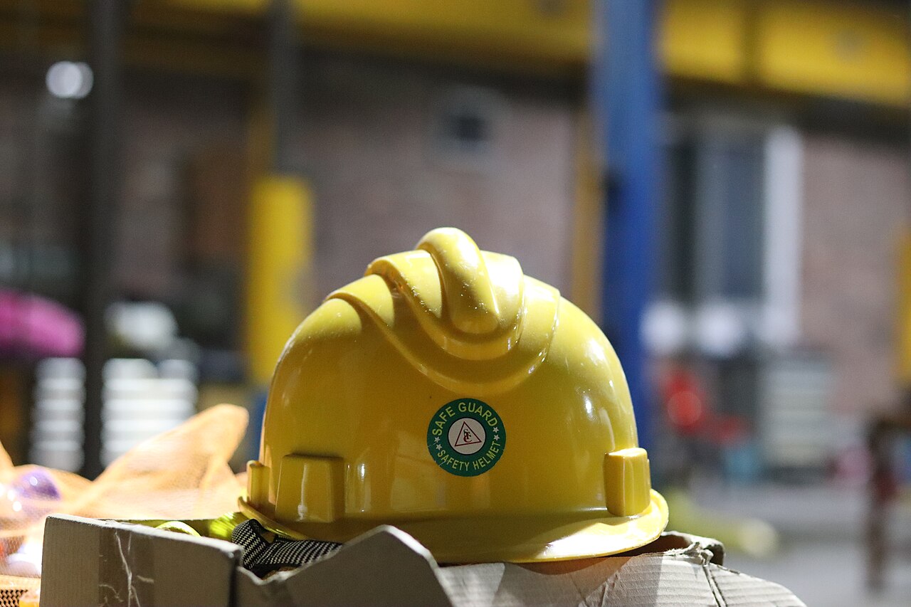 Yellow safety helmet in an industrial facility
